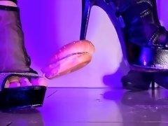 Merciless foot mistress crushing food with high heels