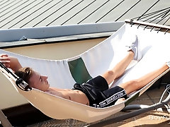 Gorgeous twink David Sky is relaxing in the hammock on the