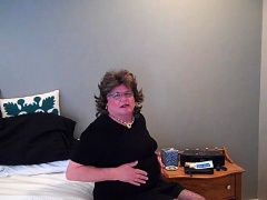 Hot mature crossdresser in stockings masturbates on the bed